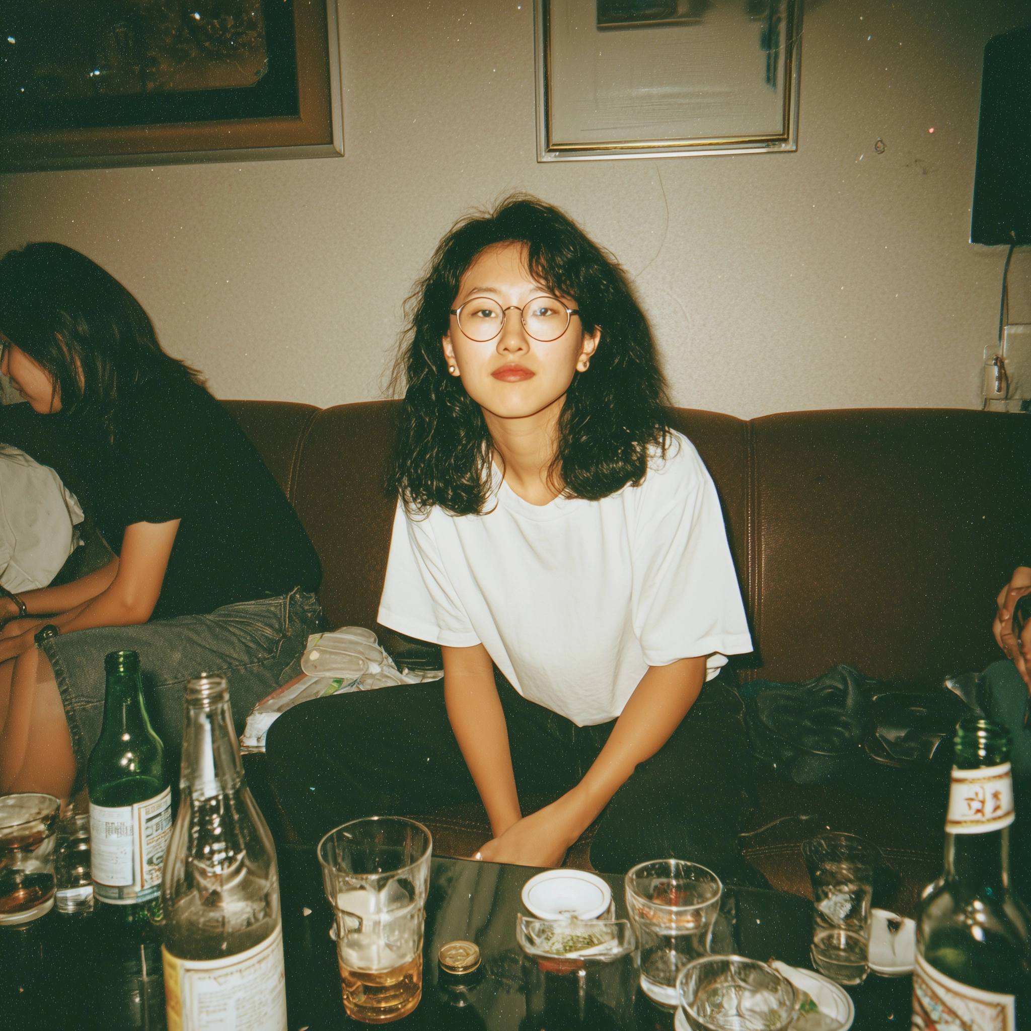 A candid flash photograph of an awkward nerdy Asian woman in her 20s with medium-length black curly
