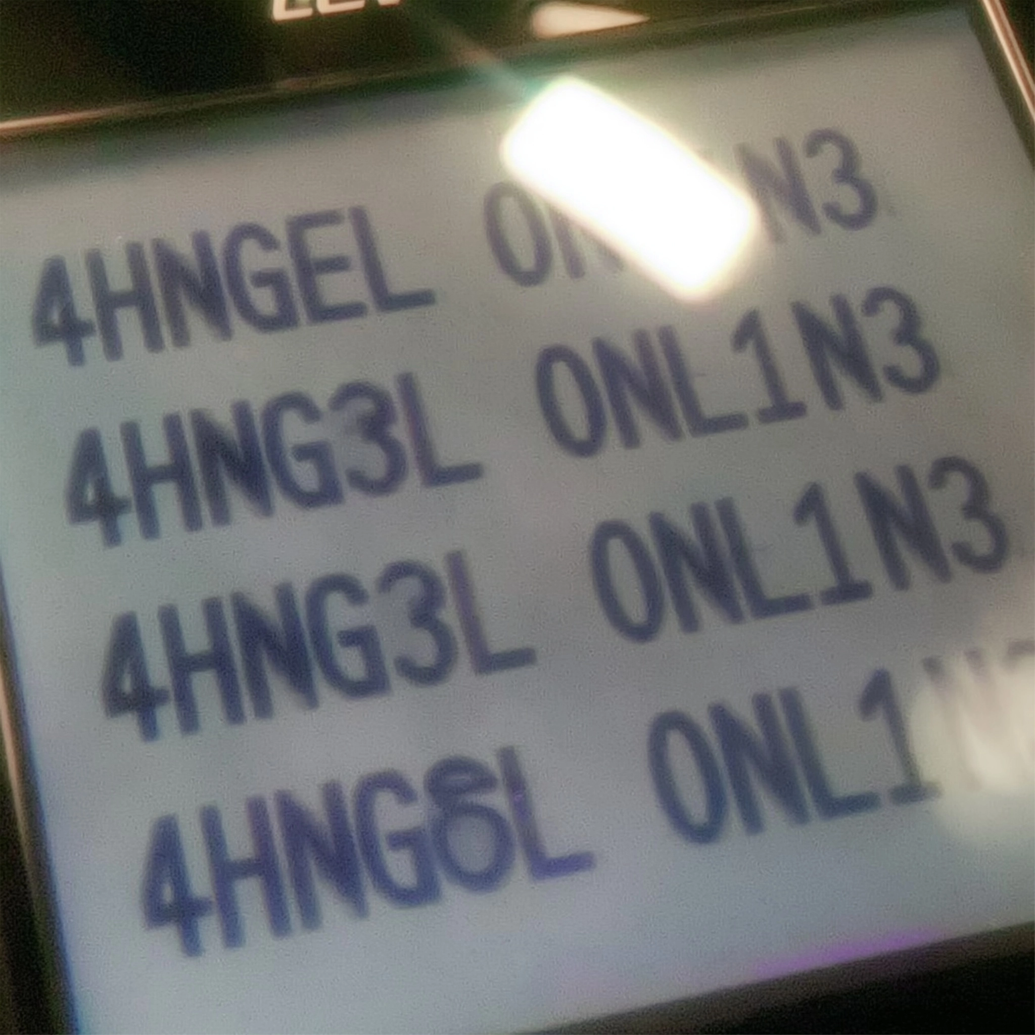 A photo of the text "Ahngel Online" "4HNG3L ONL1N3"multiple times, on an old cell phone screen.