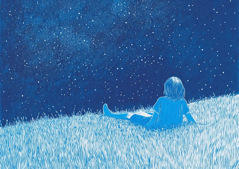 Girl lying on soft grass stargazing
