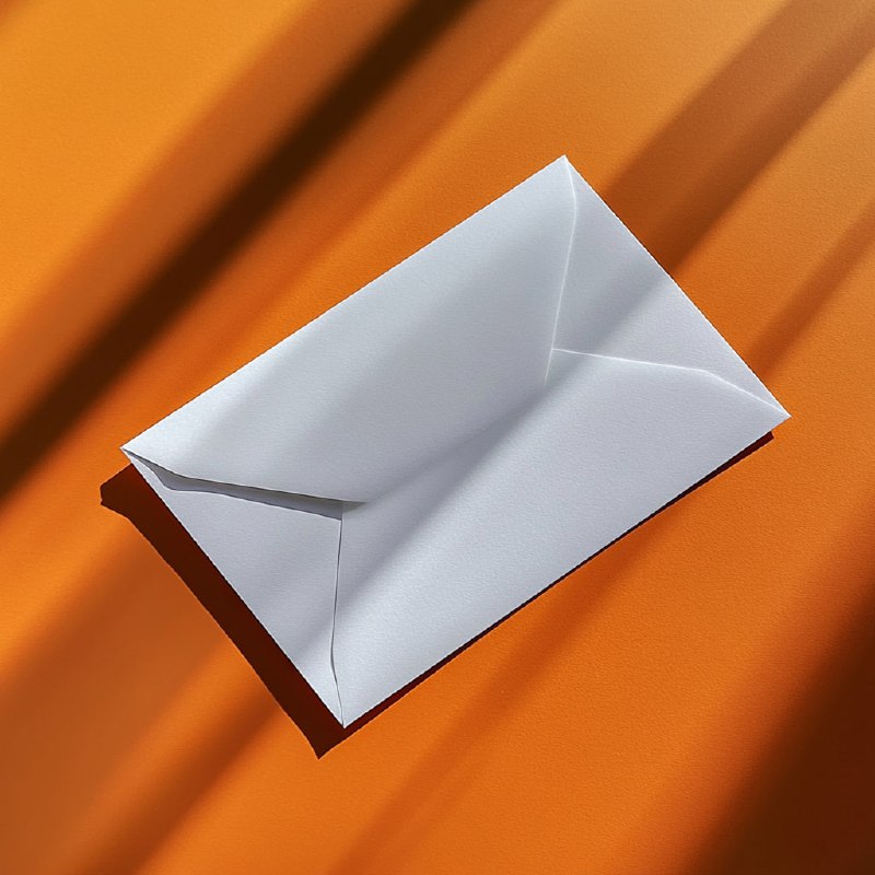 White envelope on orange table