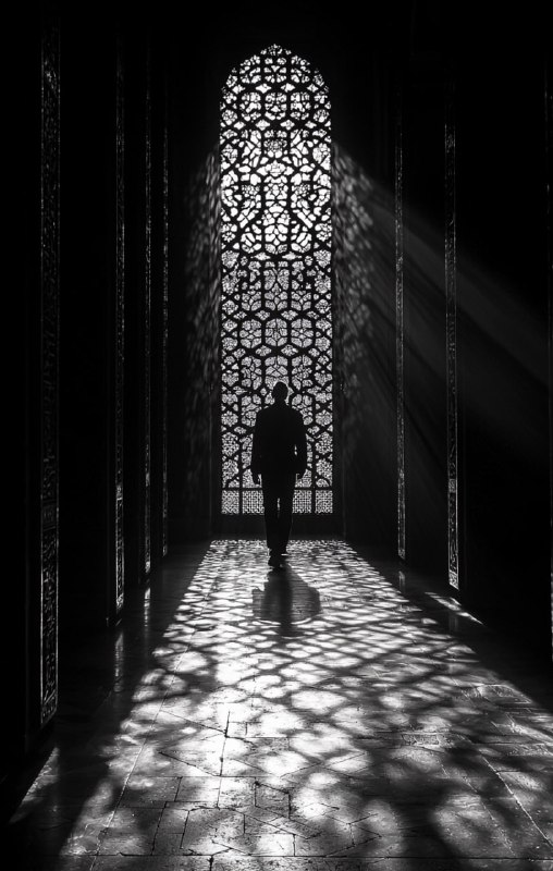 Silhouette at night intricate window