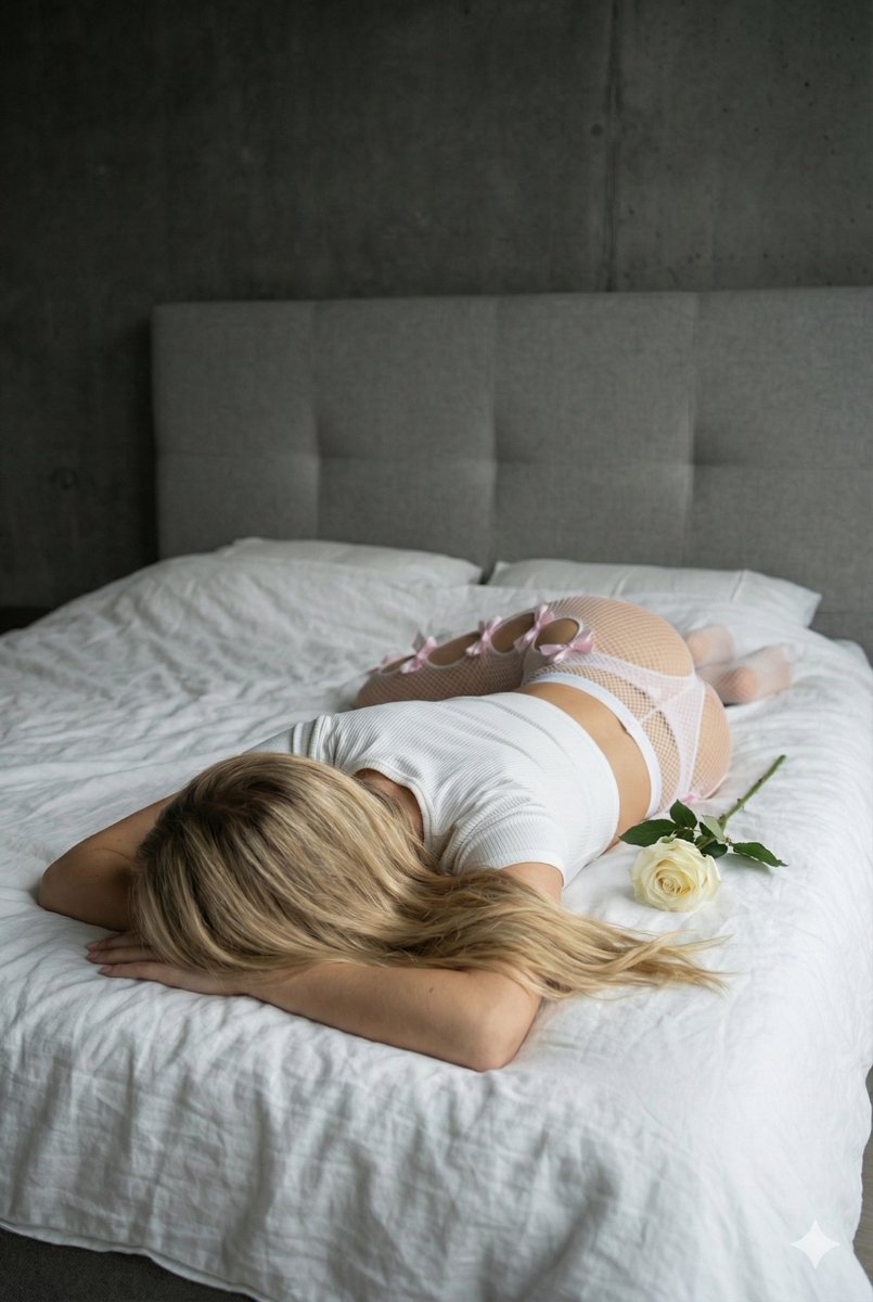 Blonde Girl Holding Rose In Bedroom