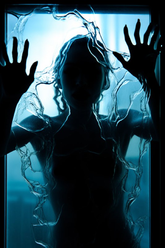 Woman's Silhouette Through Pitted Glass Fists Raised