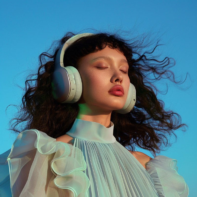 Female Model in Wireless Headphones Indigo and Gold