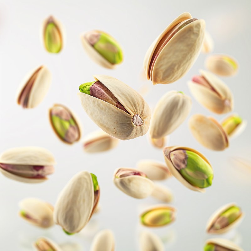 Giant Pistachios Floating on White Background