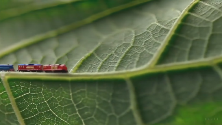 Prompt: Macro shot leaf and tiny trains