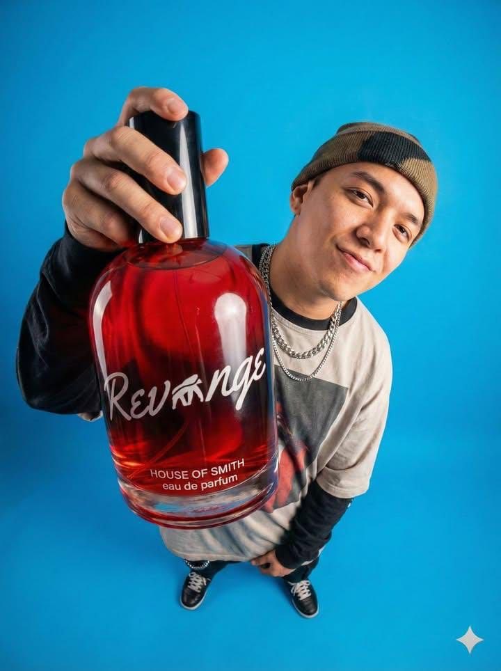 Stylish Man Holding Red Perfume Bottle