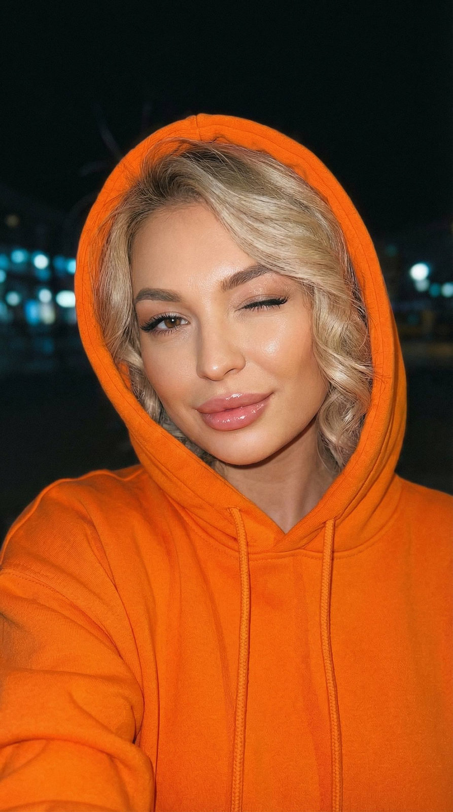 Playful Orange Hoodie Wink