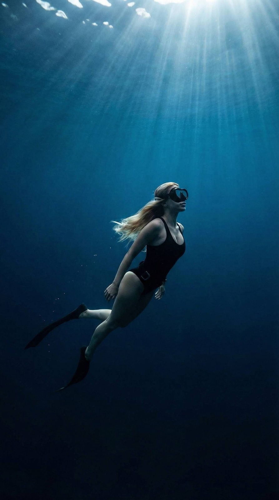 Girl Swimming Underwater In Ocean