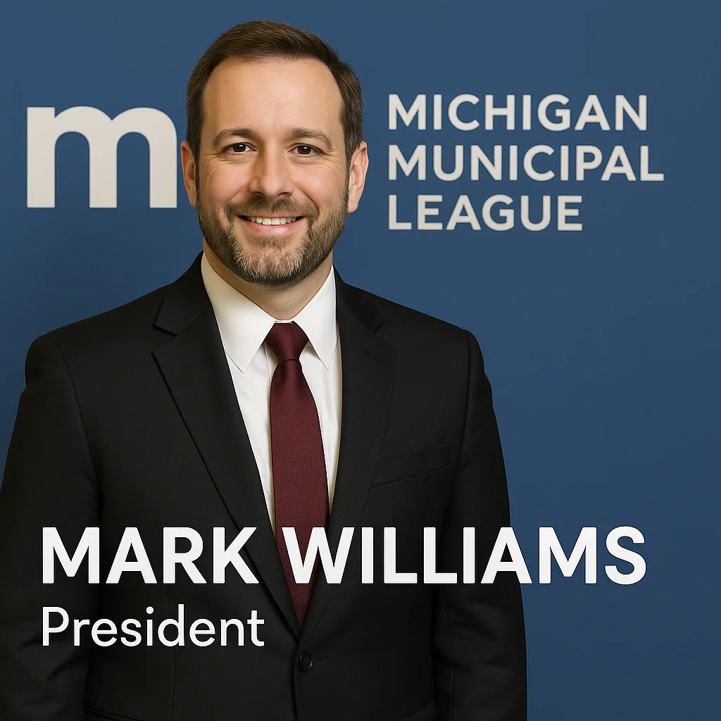 Man in Formal Attire Stands in Front of a Michigan