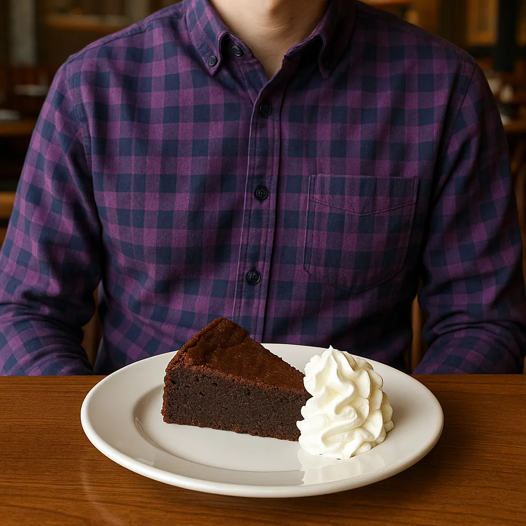 Person Wearing a Purple Checkered Shirt Sits at a Restaurant