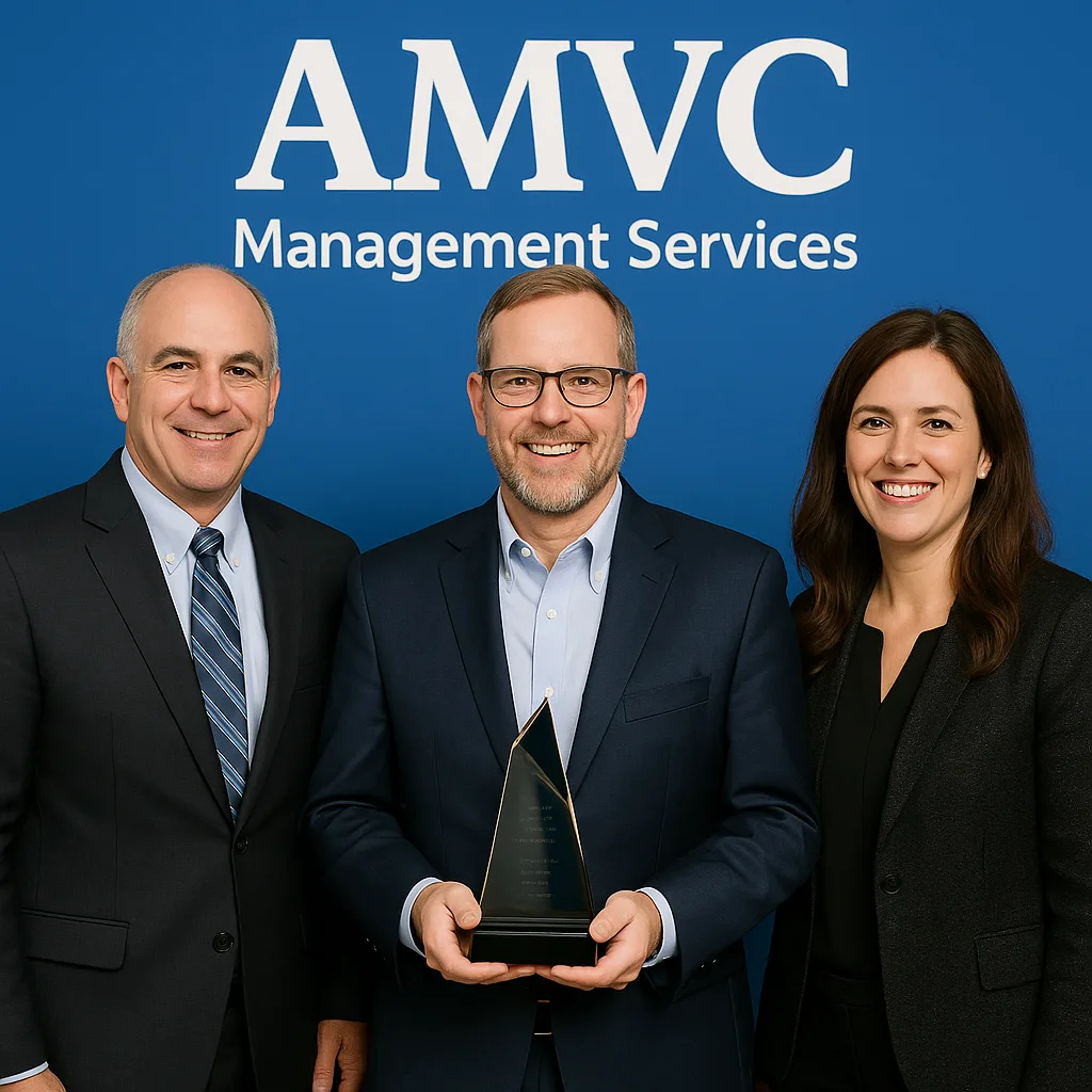Three Individuals Standing in Front of an "AMVC Management Services"