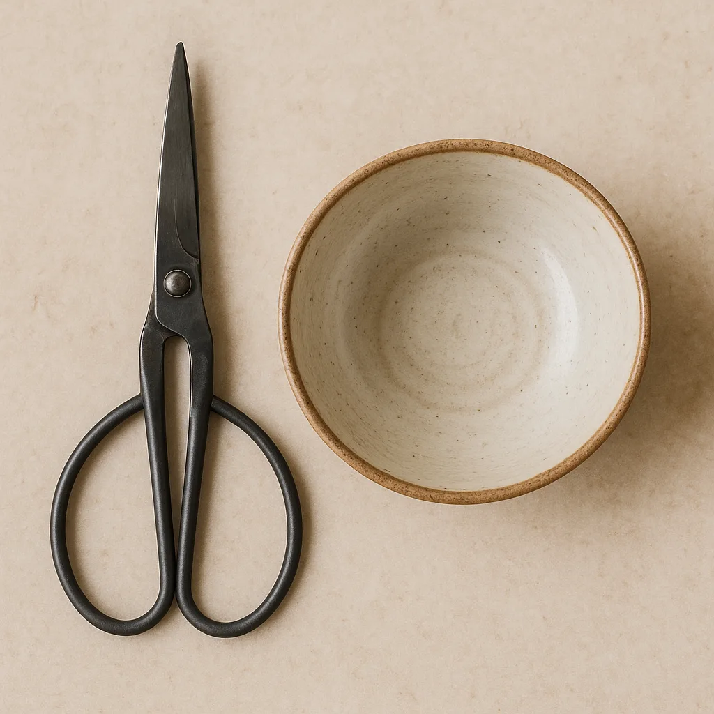 Ceramic Bowl with a Pair of Scissors Placed Beside It