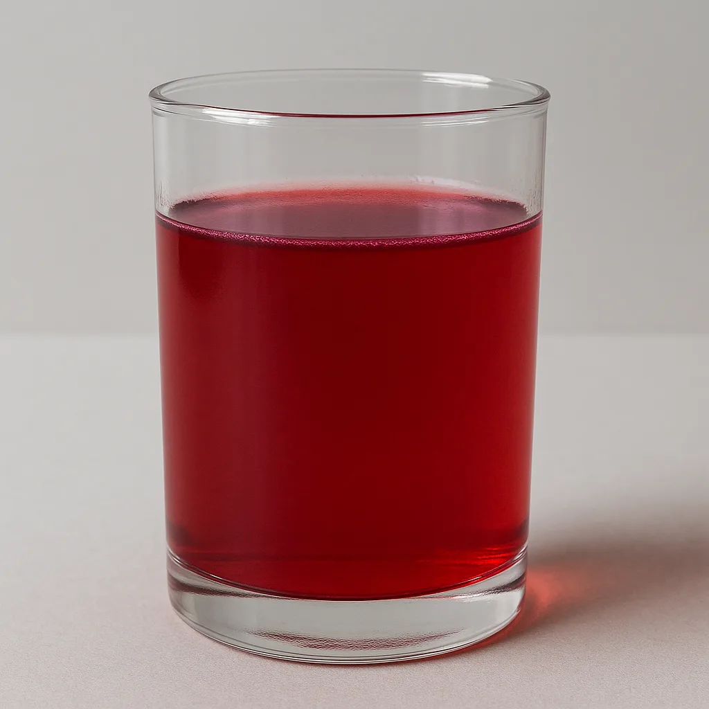 Transparent Vessel Filled with Orange Juice Combined with Litmus Solution