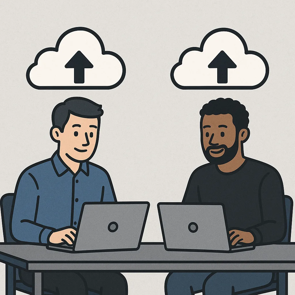 Two Men Sitting at Desks Using Laptops