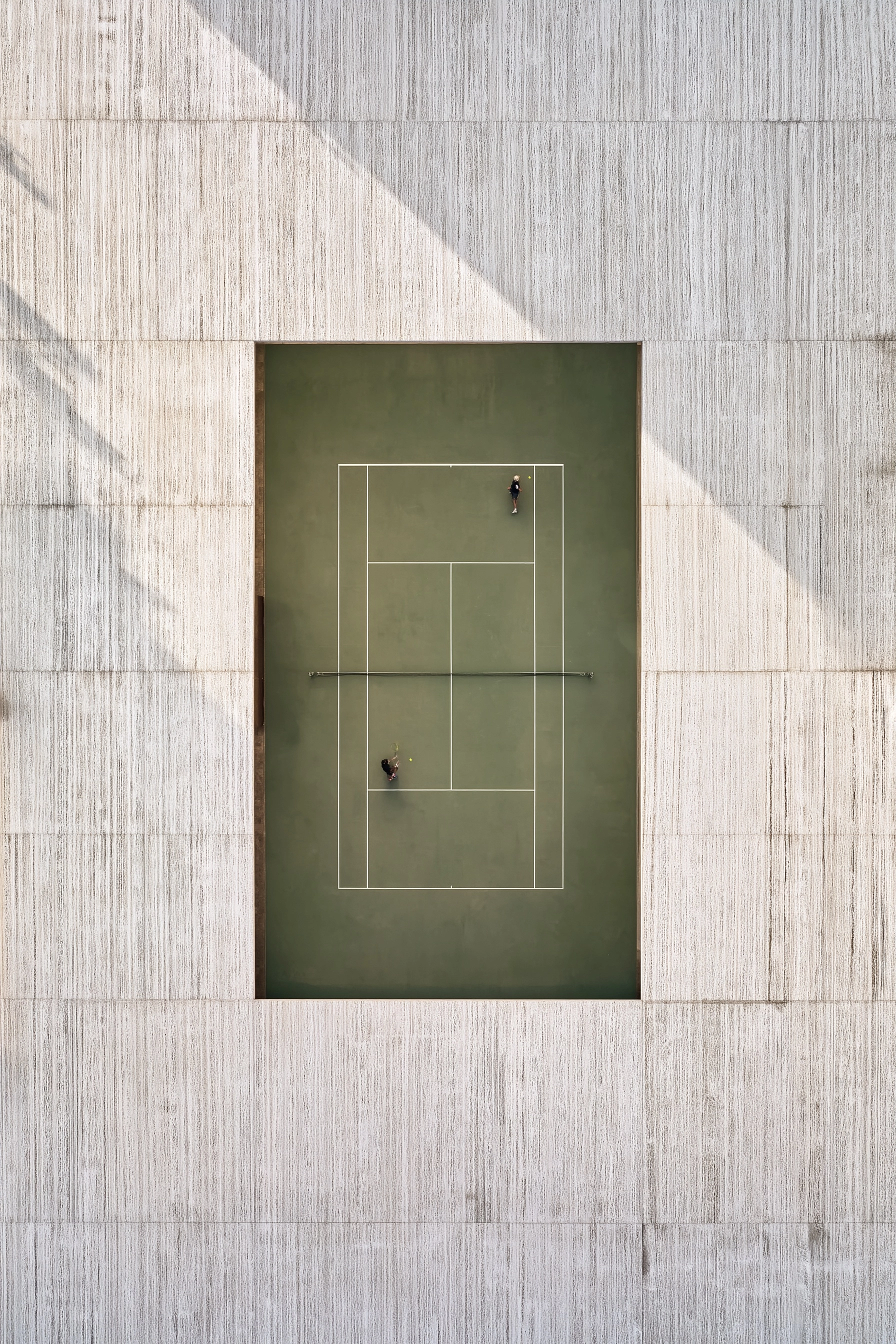 Strict top-down orthogonal architectural view of a luxury modern tennis court centered in the frame