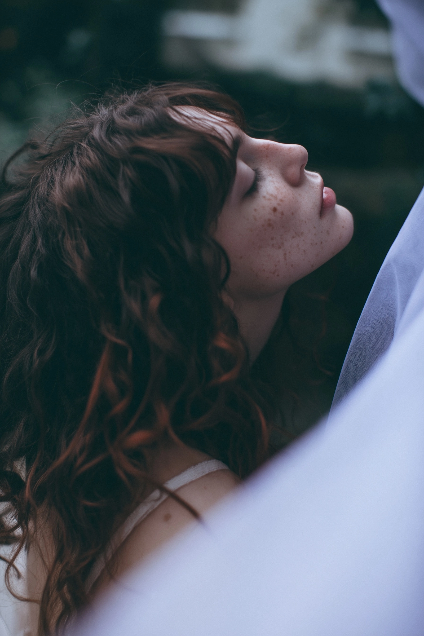 A real picture of a brunette woman, she is wearing an ethereal white dress