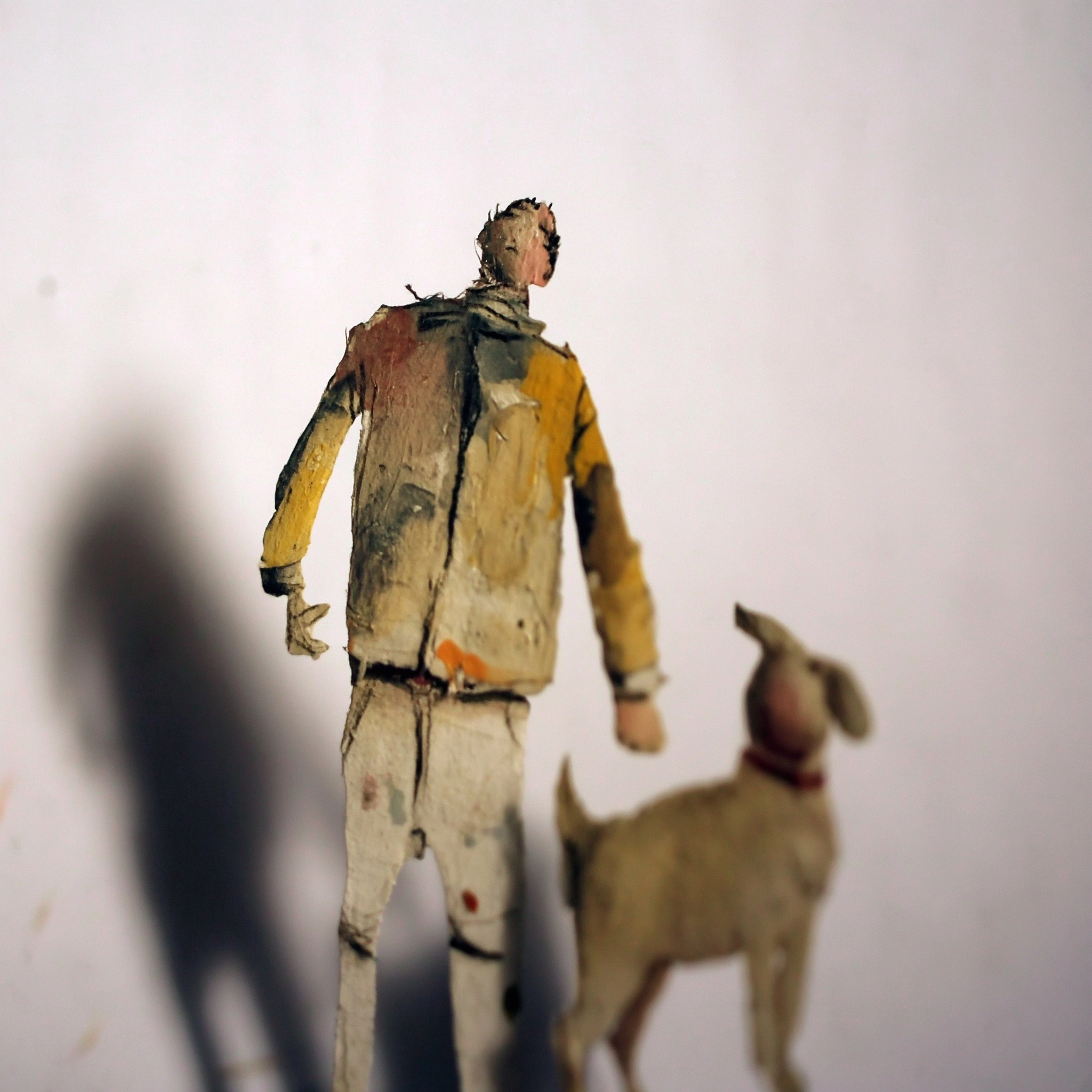 Create a surreal human character, a flat creature made of a piece of paper