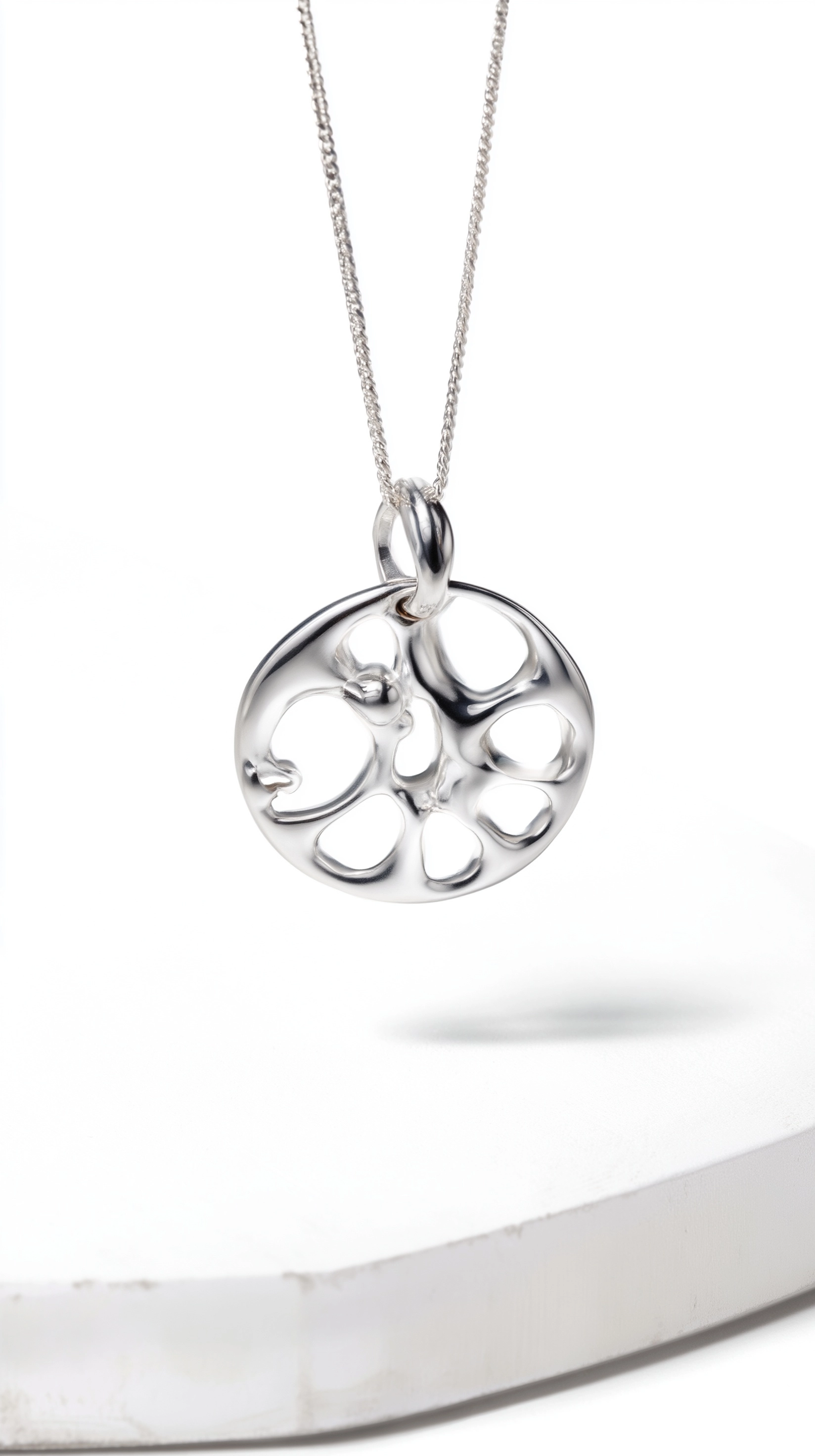 A silver pendant with an abstract pattern, designed in the style of gentle monster brand