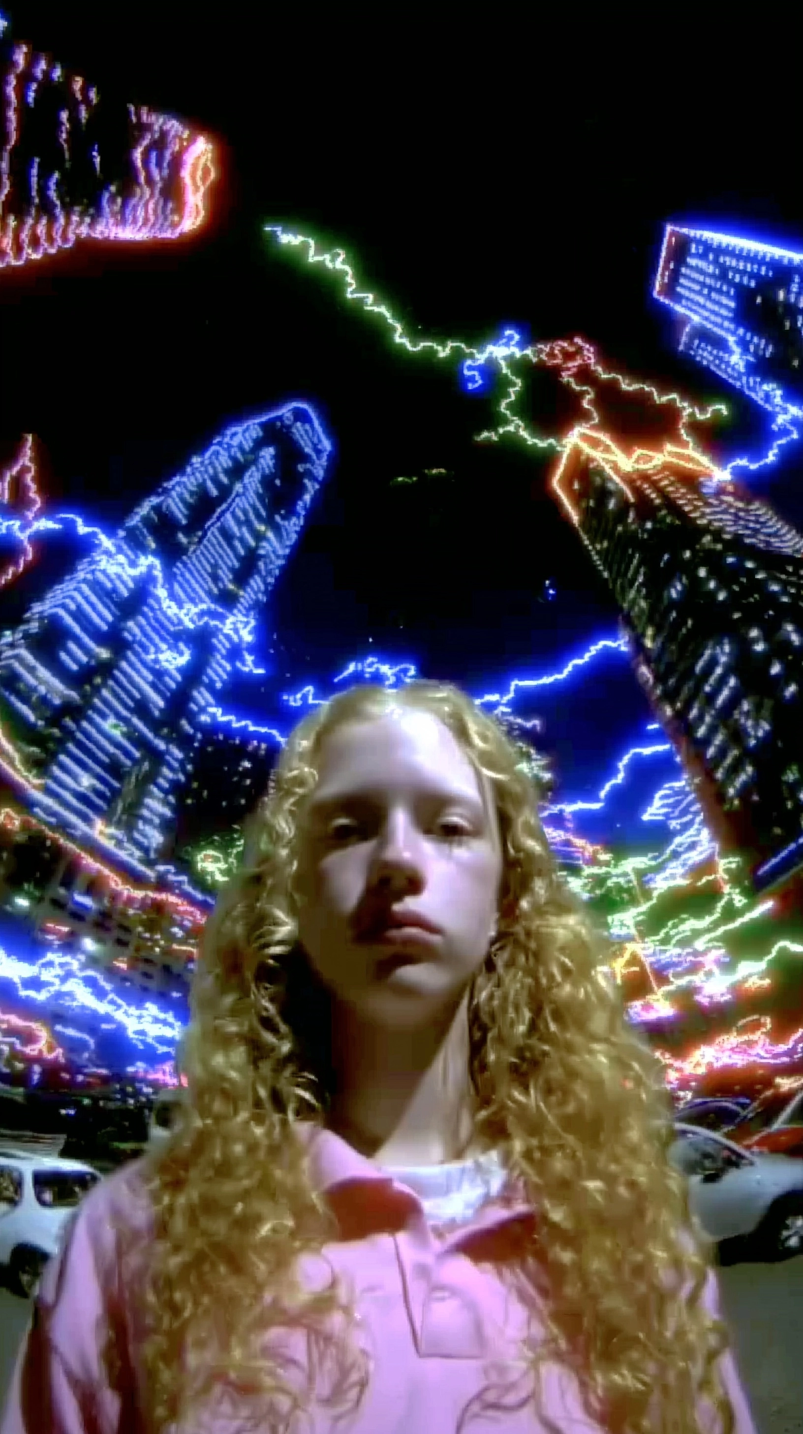 A young woman with long curly blonde hair, fair skin, realistic face