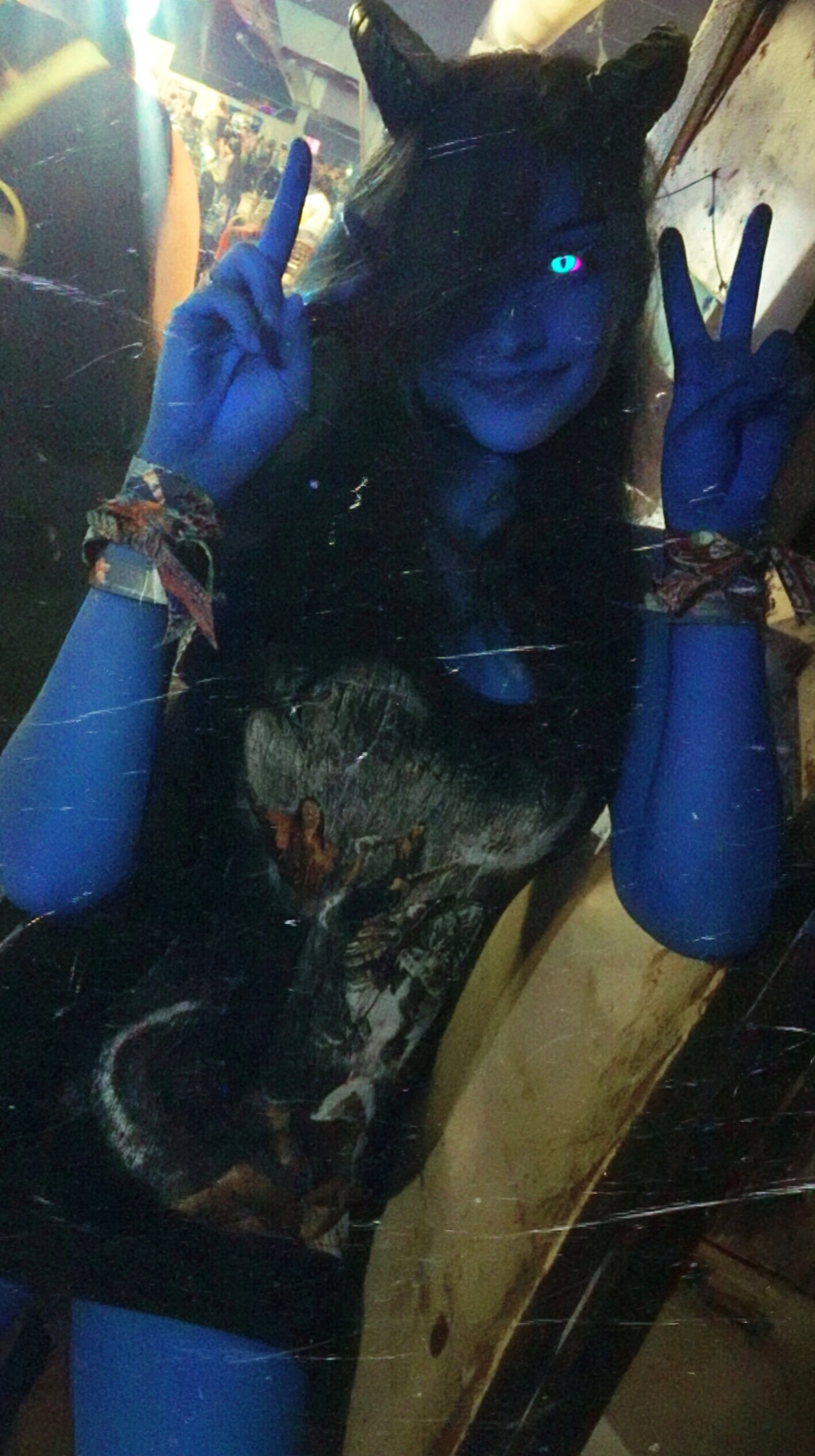 A candid, low-quality smartphone photo of a tall, athletic tiefling woman with smooth