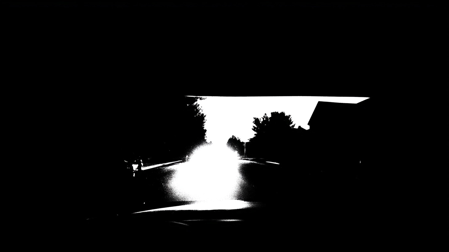 POV of a car driving down a suburban street at night