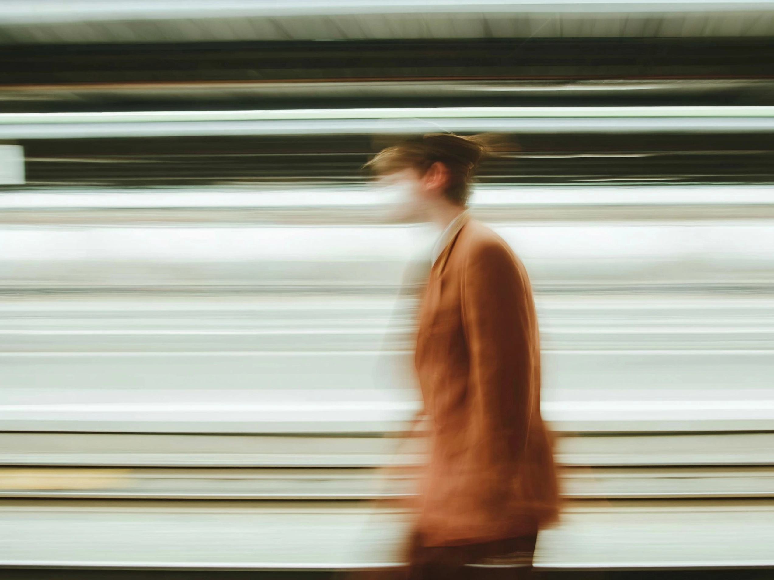 A railway employee is passing by a railway sceenary in france. the character is featured with a heav
