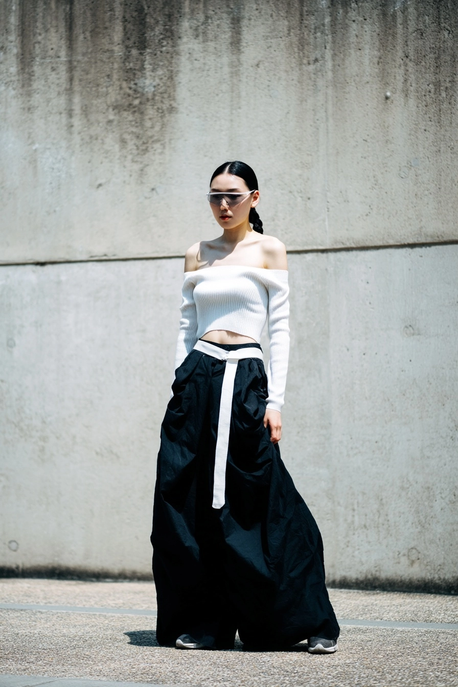 Luxury editorial street casting photo, real Korean woman in her 20s, strong memorable face