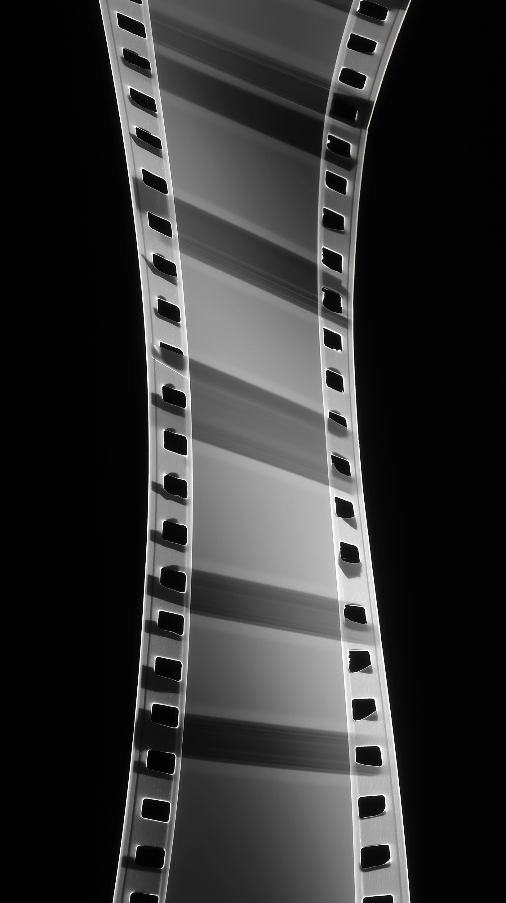 Perfectly straight vertical film strip, rigid, no deformation, no curvature at all, flat 2D