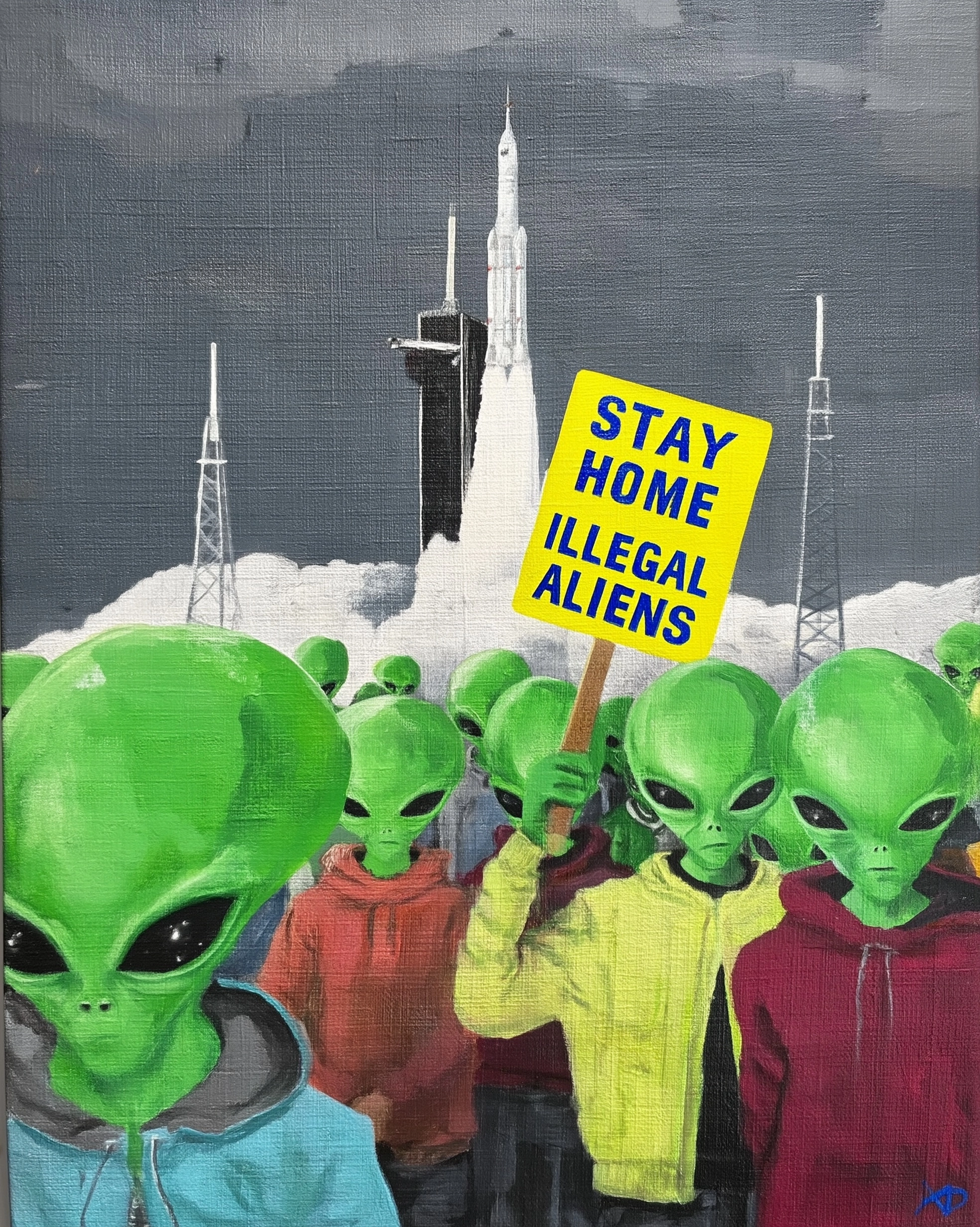 A award winning photo of green aliens protesting the launch of a rocket at Mass. The signs read "Sta