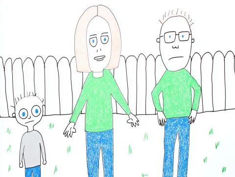 A girl and a mom holding hands inside a wooden fence