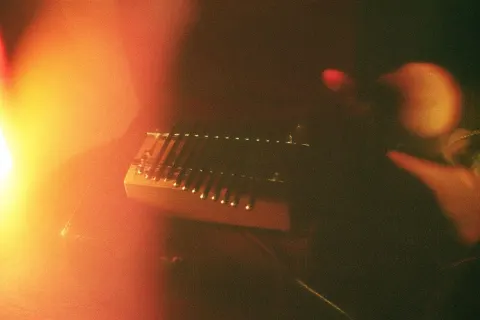A small wooden kalimba inside an old toy box, exactly seven metal tines, seven tines only