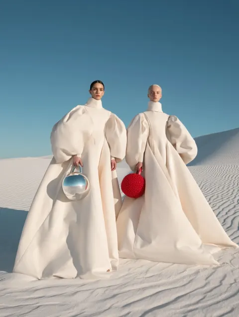 High fashion editorial, two androgynous women in white sand desert