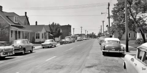 Small midwestern town in 1960s. It may not be as violent as slums