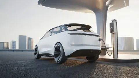 White near-future electric vehicle, heroic rear hero shot, very low ground-level camera