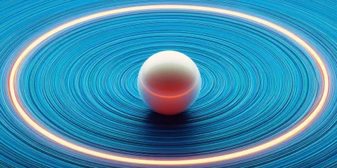 A pearl is located in the center of an abstract blue background with concentric circles