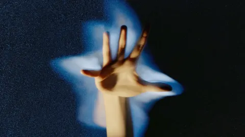 The palm stretches forward in a dynamic pose with five fingers spread open