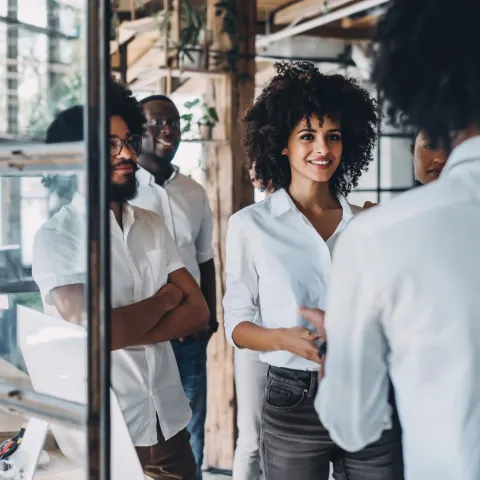 Real photograph (not illustration), authentic lifestyle business scene. Diverse multicultural team i