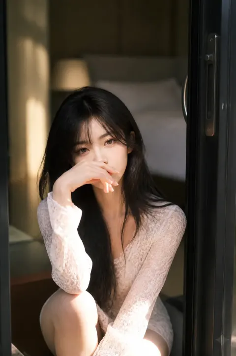A Beautiful Asian Woman with Long, Flowing Dark Hair Sits Gracefully in