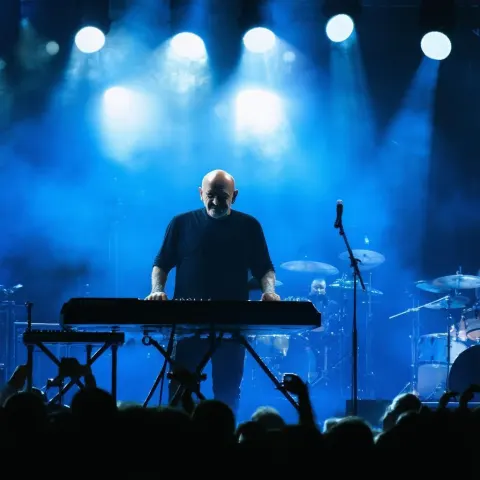Phil Collins Commanding the Stage in Vivid Light