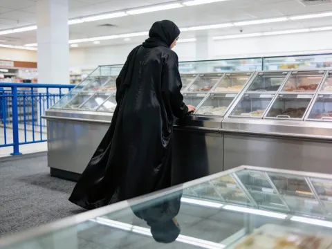 Woman In Abaya At Display Case