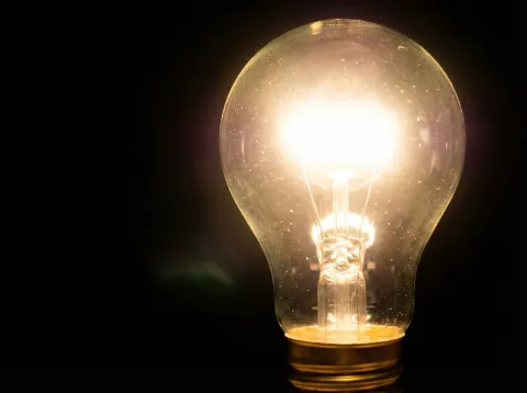 Bright Light Bulb On Black