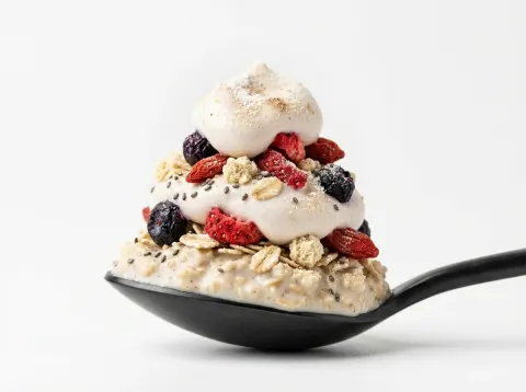 Layered Oats On A Black Spoon