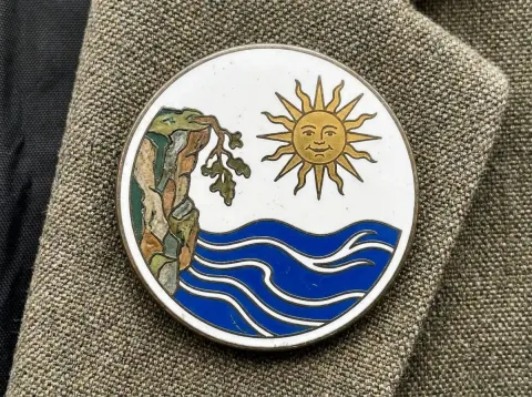 Badge With Cliff And Sun