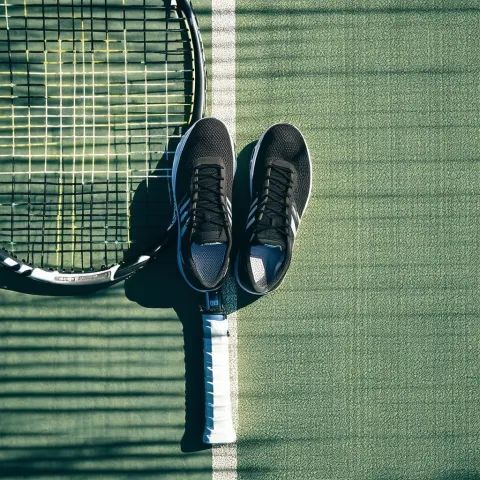 Shoes Balanced on a Racquet in Epic Light