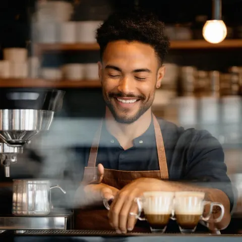 Serene Barista Smiling With Closed Eyes