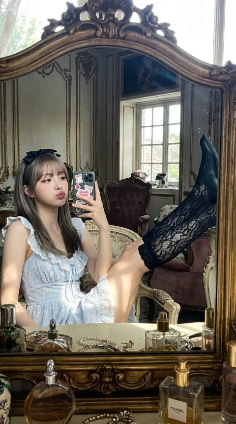 A playful young woman's mirror selfie in an opulent setting