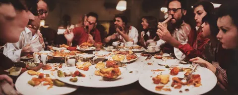 Group of People Licking from the Same Plate