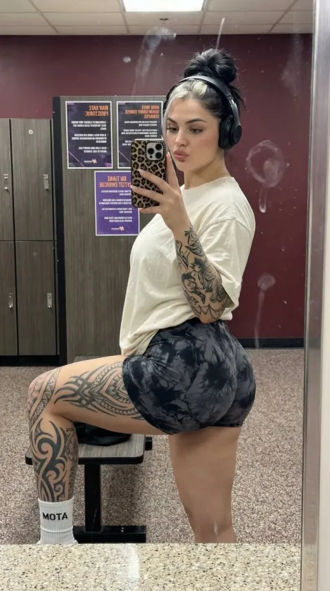 Athletic Woman Mirror Selfie with Tribal Tattoos