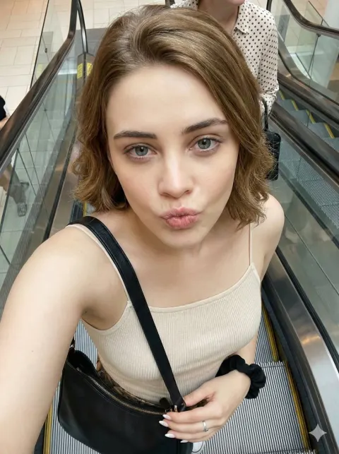 Playful Escalator Candid Selfie From Above